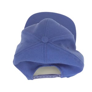 May include: A solid blue baseball cap with a flat brim. The cap features a button on top and an adjustable snapback closure. The hat is made of a sturdy fabric and is suitable for casual wear.