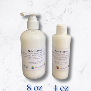 May include: Two white plastic bottles of Noble Lotion, one 8 fl oz and one 4 fl oz. The bottles have a white pump top and a white screw top. The bottles are labelled with the product name, ingredients, and directions for use. The bottles are on a white marble background.