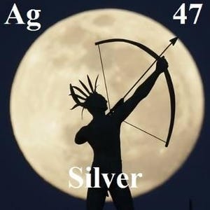 May include: A silhouette of a person holding a bow and arrow, standing in front of a full moon. The person is wearing a headdress with feathers. The text "Ag" and "47" are visible above the moon. The text "Silver" is visible below the person.