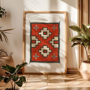 May include: A framed print of a red, white, and black geometric pattern. The pattern is reminiscent of a Native American rug or blanket.
