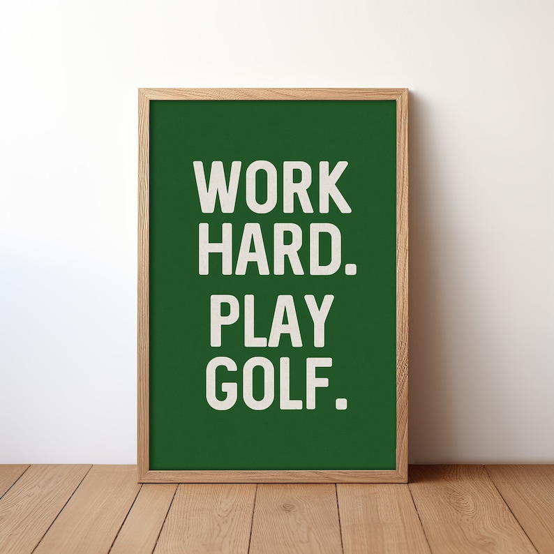 May include: A framed green poster with white text that reads "WORK HARD. PLAY GOLF."