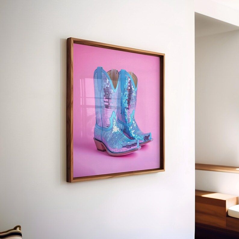 May include: A framed photograph of a pair of blue sequined cowboy boots on a pink background.