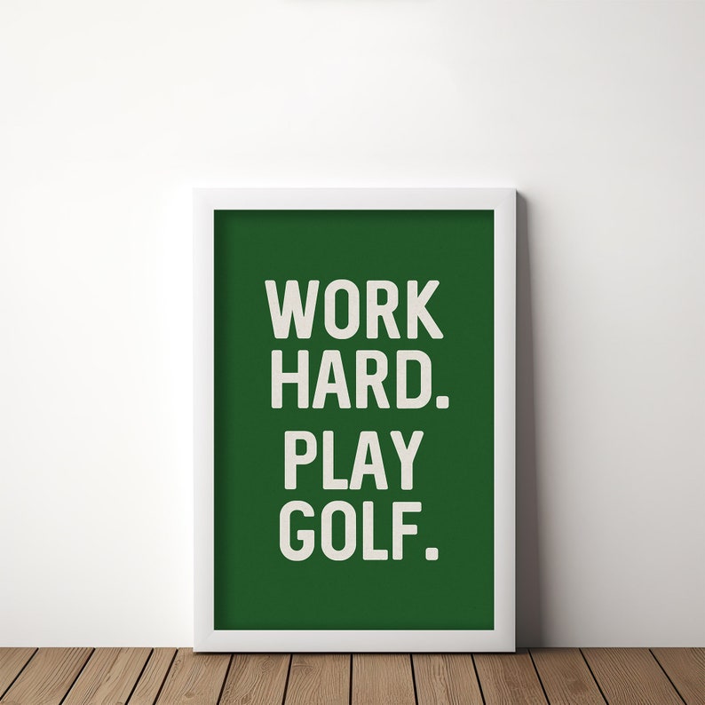 May include: A white framed print with a green background and the text "WORK HARD. PLAY GOLF." in white.