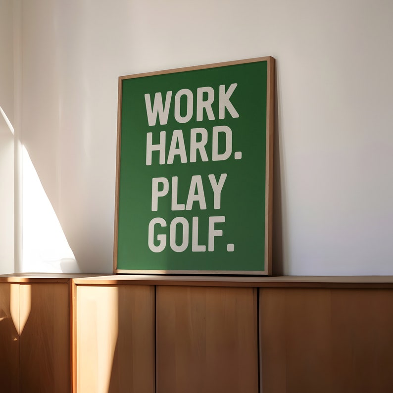 May include: A green framed poster with white text that reads "WORK HARD. PLAY GOLF."
