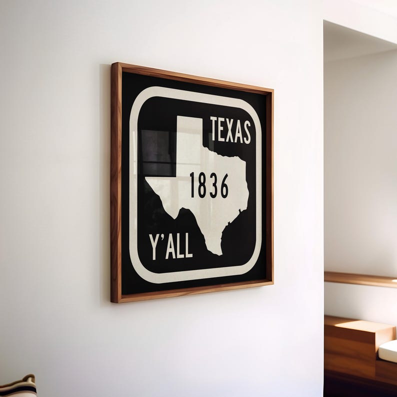 May include: A framed print with a black background and a white outline of Texas. The text "TEXAS 1836 Y'ALL" is in white. The frame is made of wood.