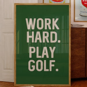 May include: A green framed poster with white text that reads "WORK HARD. PLAY GOLF."