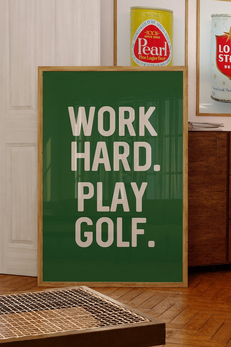May include: A green framed poster with white text that reads "WORK HARD. PLAY GOLF."