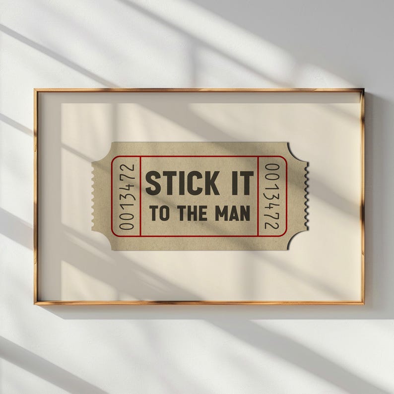 May include: A brown ticket with the text "STICK IT TO THE MAN" and the numbers "0013472" on the right side and "0013472" on the left side.