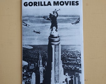 May include: A black and white photo of a magazine cover with the title "GORILLA MOVIES". The cover features a black and white image of King Kong standing on top of a building in New York City.