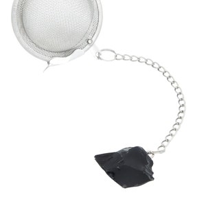 May include: A silver tea infuser with a mesh ball and a chain attached to a black obsidian stone.