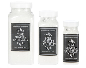 May include: Three white plastic jars of bath salts with black labels that read "New Moon Beginnings Sore Muscles Bath Salts Pure Essential Oils".