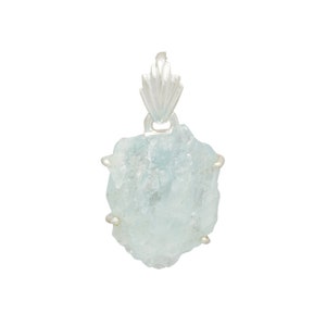 May include: A silver pendant featuring a large, light blue aquamarine crystal. The crystal is raw and has a natural, irregular shape. The pendant is attached to a silver bail.
