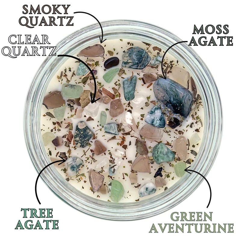 May include: A clear glass jar filled with a white candle and various types of crystals, including clear quartz, smoky quartz, moss agate, tree agate, and green aventurine.