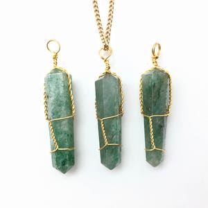 Puede incluir: Tres colgantes de piedra verde, de forma hexagonal y corte en punta, envueltos en alambre de color dorado. El colgante central est&aacute; unido a una cadena dorada, mientras que los dos laterales tienen un lazo de alambre en la parte superior.