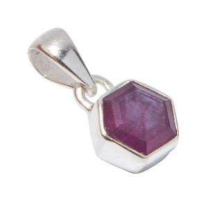 May include: A silver pendant with a hexagonal purple gemstone.