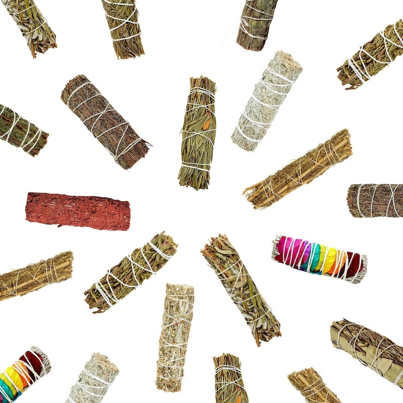 May include: Assortment of smudge sticks in various colors and textures, including white sage, palo santo, and red cedar. The sticks are tied with twine and are ready to be burned for cleansing and purification.