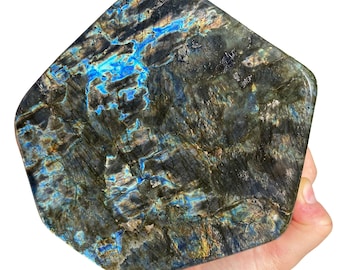 May include: A large, irregularly shaped piece of labradorite with a dark gray, blue, and green iridescent sheen.