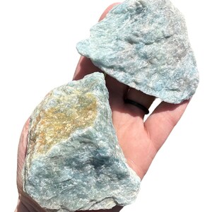 a person holding two rocks in their hand