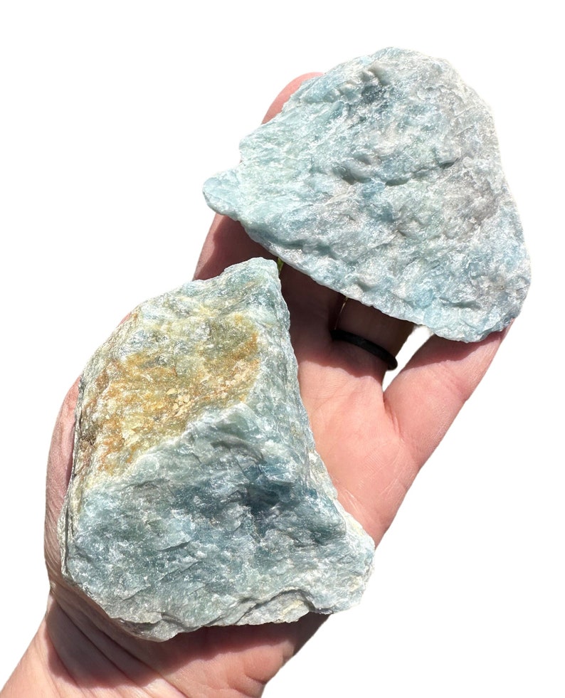 a person holding two rocks in their hand