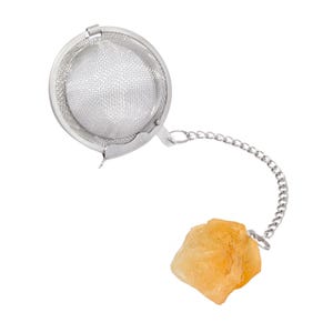 May include: A silver tea infuser with a mesh ball and a chain attached to a yellow rock.