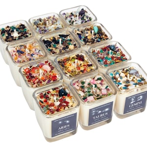 May include: Twelve square glass candle jars with a white wax base and various colored crystals and stones embedded in the wax. Each jar has a label with the name of a zodiac sign and the text "New Moon Beginnings" and "All Natural Candles".