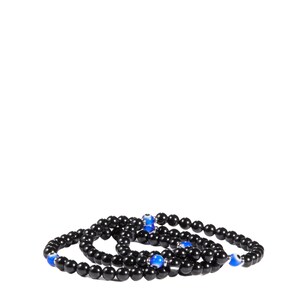 May include: Three black beaded bracelets with blue and silver accents. The bracelets are made of small, round, black beads and feature blue eye-shaped beads interspersed throughout. The bracelets are arranged in a layered style.