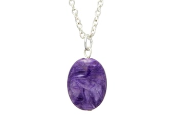 May include: A silver chain necklace with a purple oval pendant. The pendant is made of a natural stone with a swirling pattern.