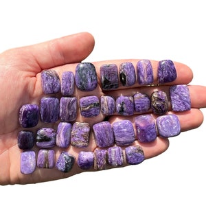 May include: A collection of 20 tumbled stones in shades of purple and silver. The stones are smooth and polished, with a variety of patterns and textures.
