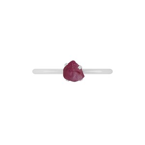 May include: A silver ring with a pink, rough-cut gemstone.