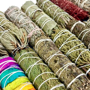 a bunch of different types of herbs on a table