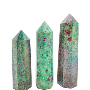 May include: Three green and pink ruby in zoisite crystal points of varying sizes. The points are faceted and have a natural, rough texture.