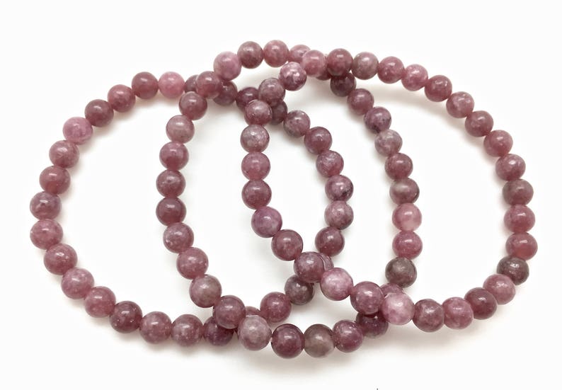 Puede incluir: Tres pulseras de piedra de lepidolita rosa con cuentas redondas.
