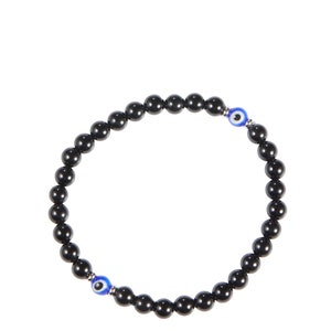 May include: Black beaded bracelet featuring two blue and white evil eye charms. The bracelet is made of small, round, polished black beads strung together. The evil eye charms have a blue iris and white highlights.