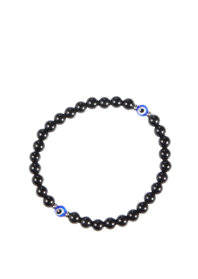 May include: Black beaded bracelet featuring two blue and white evil eye charms. The bracelet is made of small, round, polished black beads strung together. The evil eye charms have a blue iris and white highlights.