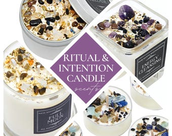 May include: A collection of candles featuring white wax topped with various tumbled gemstones and dried herbs. Labels on the containers display the text "RELEASE," "ENERGY CLEANSING," and "FULL MOON" alongside the brand name New Moon Beginnings.