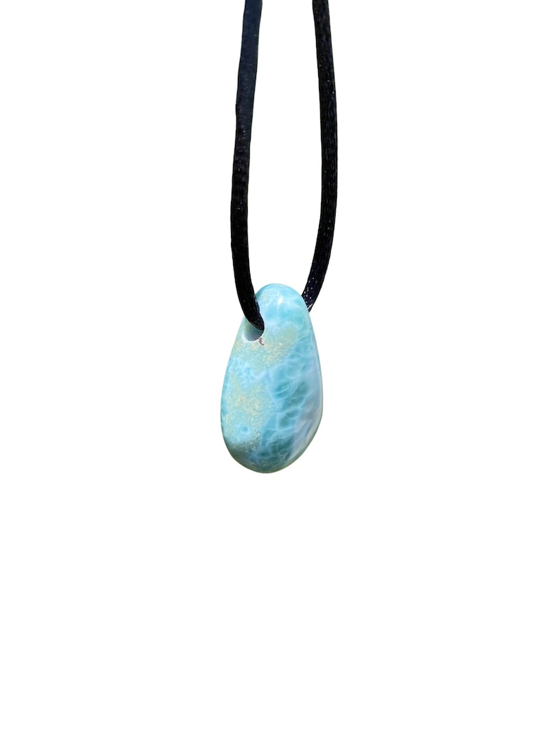 May include: A blue and green gemstone pendant on a black cord necklace.