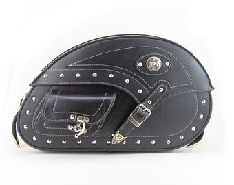 May include: Black leather motorcycle saddlebag with silver studs, buckles, and a decorative metal plate. The bag has a small pocket on the front and a white stitching detail.