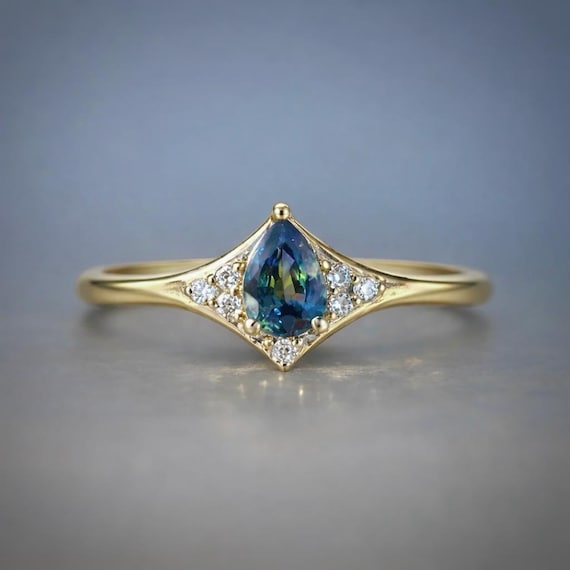 Custom-made 14K Yellow gold Aurora ring with Pear Sapphire and Diamonds