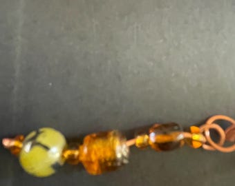 Copper spiral dreadlock cuff with beads and gems.
