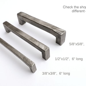 May include: Three metal cabinet pulls in different sizes. The pulls are 6 inches long and have a hammered finish. The sizes are 5/8 inch by 5/8 inch, 1/2 inch by 1/2 inch, and 3/8 inch by 3/8 inch.