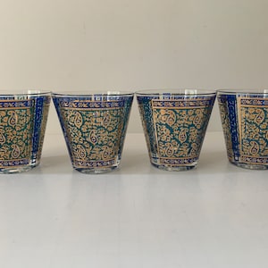 May include: Set of four clear glass tumblers with a blue and gold paisley pattern.