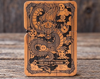 May include: A rectangular wooden lighter case featuring a laser-engraved design of a dragon surrounded by clouds and spherical star-marked orbs. The text "YOUR WISH IS MY COMMAND" is centred at the bottom within a decorative border.