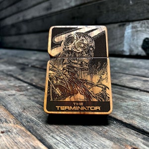 May include: A wooden box with a laser-engraved image of the Terminator from the movie "The Terminator". The box has the text "The Terminator" on the front.