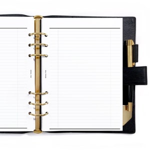 May include: A black leather bound planner with gold rings and a pen in the side pocket. The planner is open to a blank lined page.