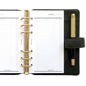 May include: A black leather bound planner with gold rings and a pen. The planner has a white page open with the words "ORDER tracker" at the top. The page is divided into two columns with headings for "Date", "Item/Desc", "Qty", "Amt", and "Check".