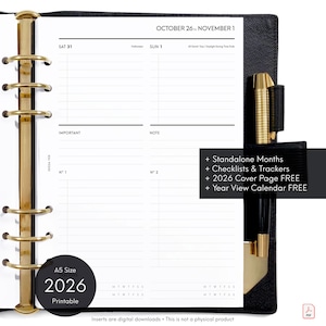 May include: Black A5 size 2026 printable planner insert with gold-coloured metal rings. The planner shows a calendar view for October 26 to November 1, with space for notes and checklists. Text on the insert includes "Standalone Months," "Checklists & Trackers," and "2026 Cover Page FREE."
