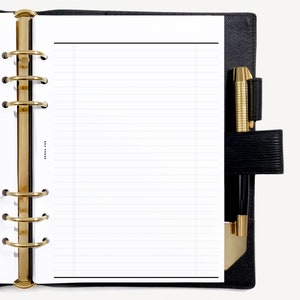 May include: A black leather bound planner with gold rings and a pen holder. The planner has lined pages and a black pen is inserted in the pen holder.