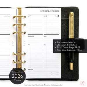 May include: A black personal size 2026 printable planner with gold-colored rings and a pen. The planner is open to a weekly spread, with the dates November 2 to November 8 visible. Text includes "Standalone Months", "Checklists & Trackers".
