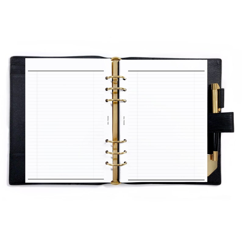 May include: A black leather bound planner with gold rings and a pen in the side pocket. The planner is open to a blank lined page.