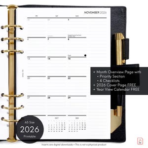 May include: Black A5 size 2026 printable planner with gold accents. The planner is open to a November 2026 monthly view. Features include a priority section, checklists, and a 2026 cover page. A gold pen is secured in the binding.